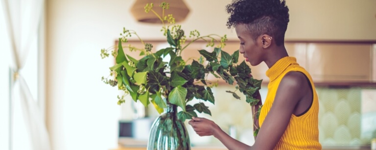 Interior designer places flowers in home