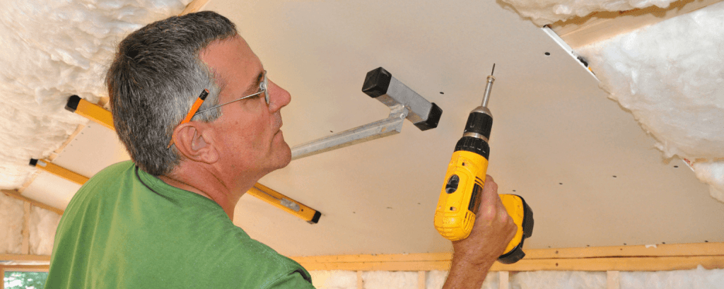 Contractor with a Georgia business insurance installs a ceiling