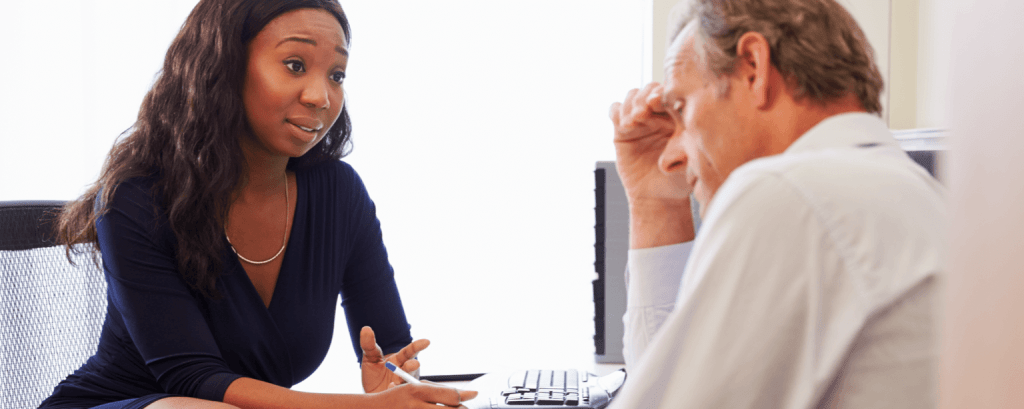 Small business owner with a GA business insurance discusses options with a client