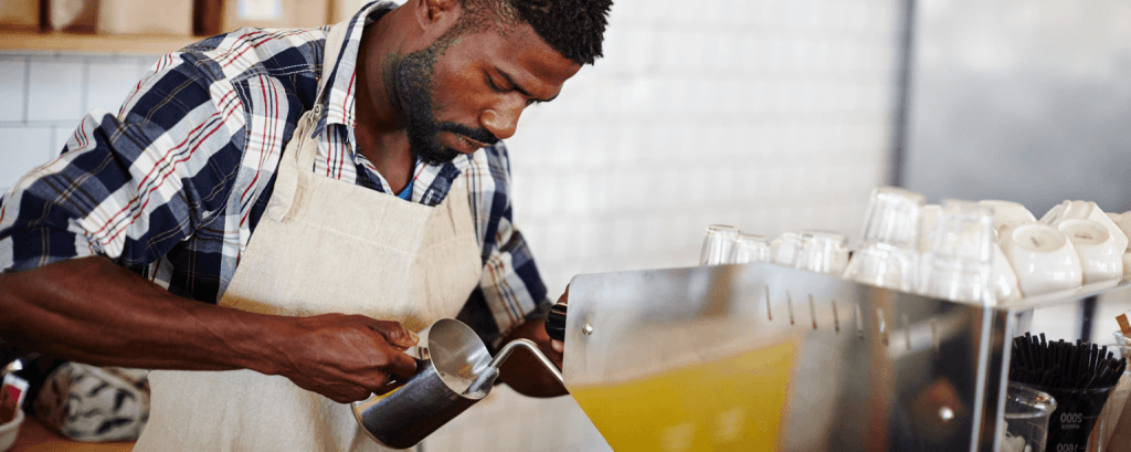 Barista makes drink in cafe