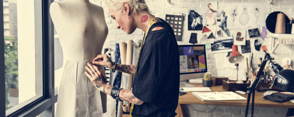 Business owner organizes clothes in retail shop