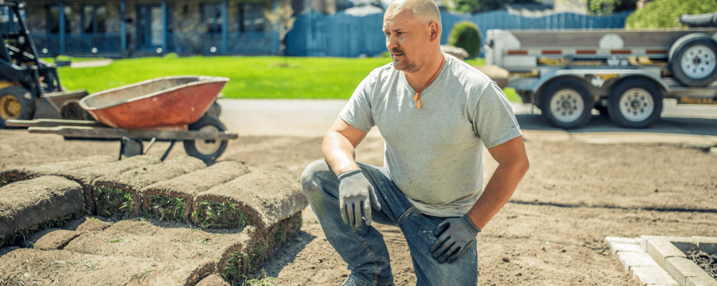 Landscaper surveys jobsite