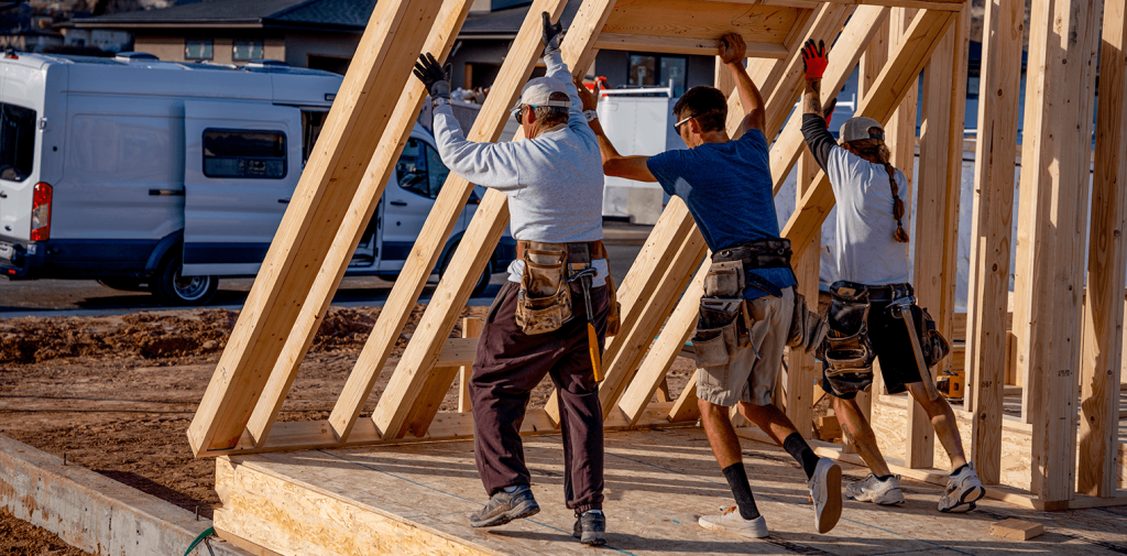 Three workers who have workers’ comp insurance are building a house

