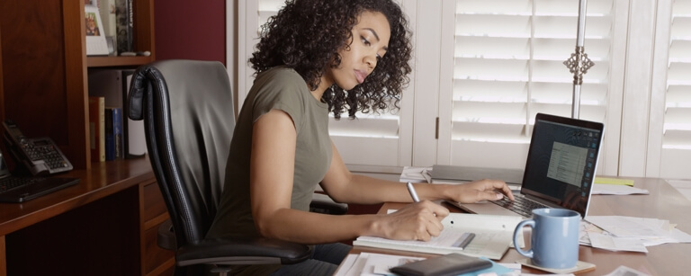 Accountant working at desk with laptop