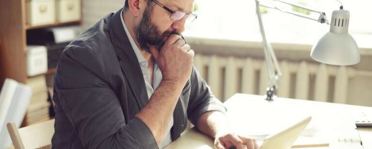 Male accountant reviewing work at desk