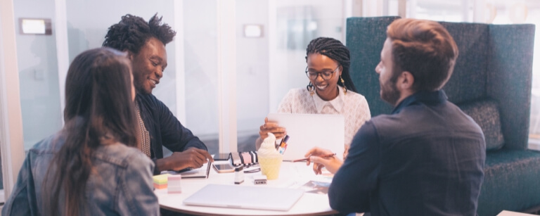 Ad agency staff meets at table