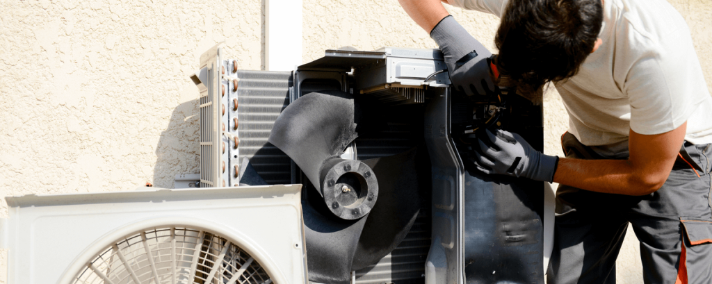 HVAC tech working on an AC unit