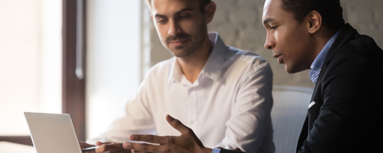 Business consultant working with client at desk