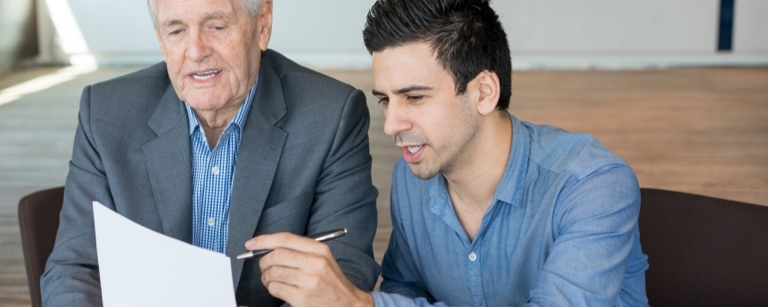 Business consultant working with client using pen and paper