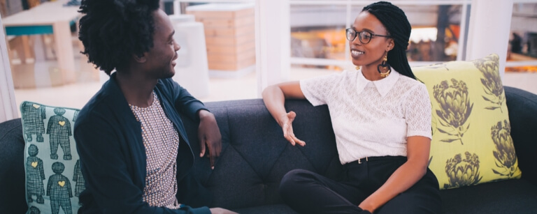 Life coach who owns life coaching insurance is meeting with a client 

