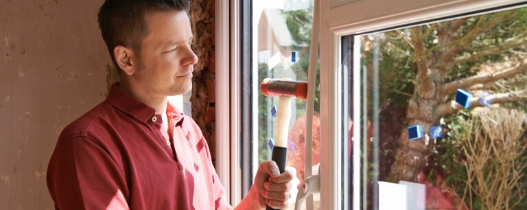 Man installs sliding door into frame
