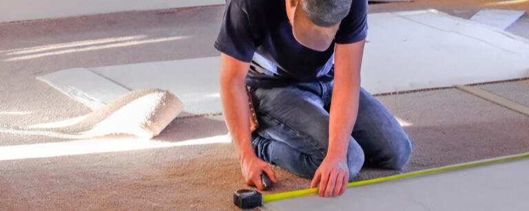 Flooring contractor working with carpet
