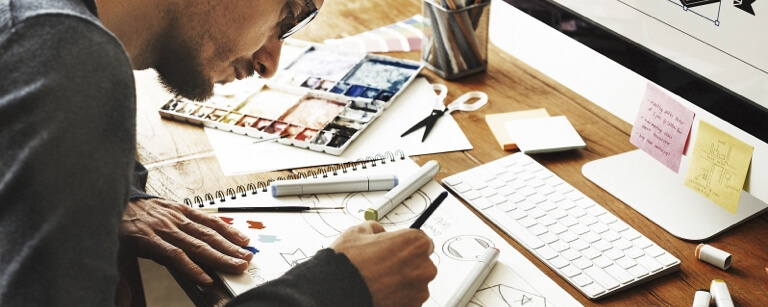 Female graphic designer working with pen and paper