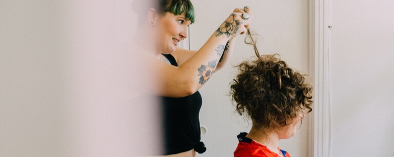 An insured Hair salon employee styling a client's hair