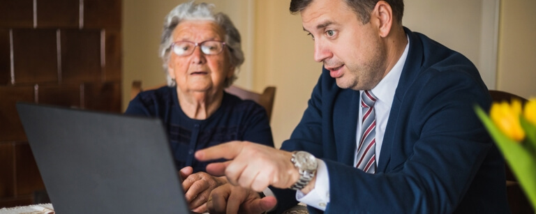 A lawyer meeting with a client using a laptop
