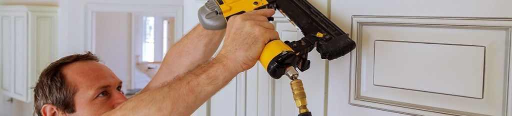 Carpenter installing a cabinet