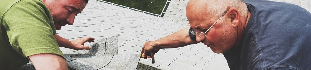 Two men installing shingles