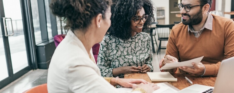 Mortgage broker meets with couple in office