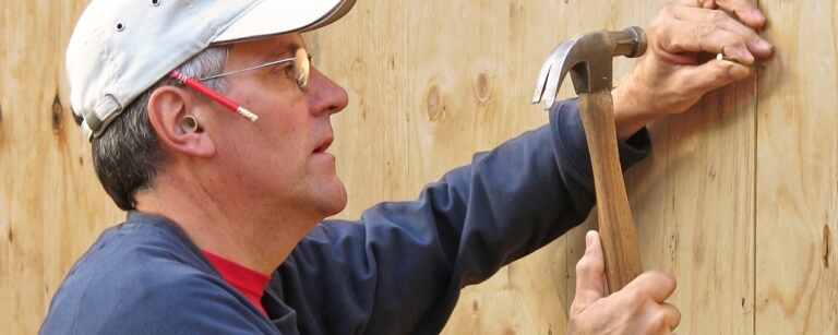 Insured contractor hammering a nail