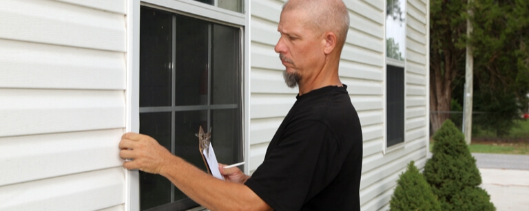 Property manager inspecting a window