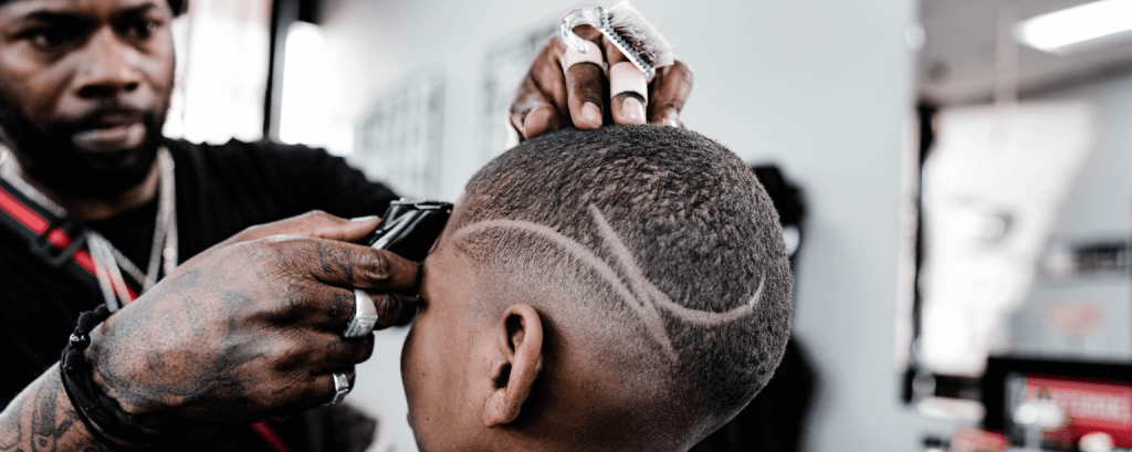 Barber cuts hair of child
