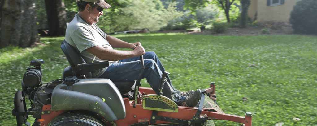 Lawn care worker with CA business insurance is working using a mower