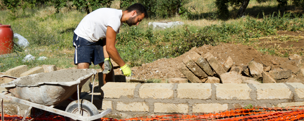 Landscaper builds retaining wall