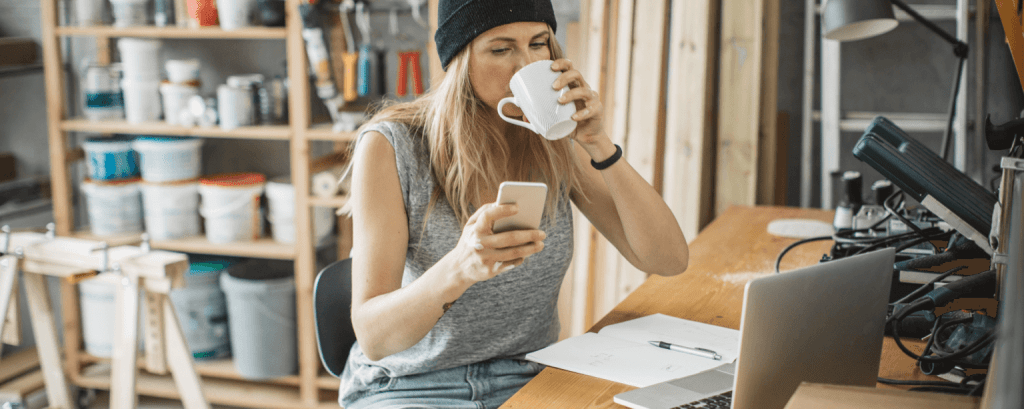 Contractor checks email on her phone
