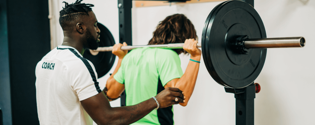 Personal trainer with a California business insurance is helping out a client