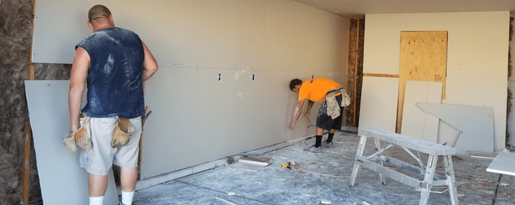 Contractors hang dry-wall
