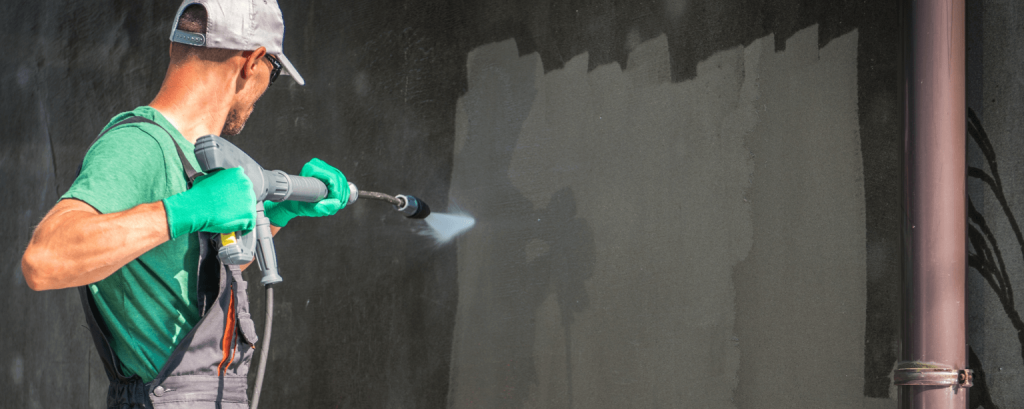 Pressure washer cleans wall