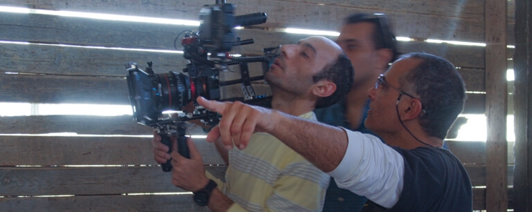 Camera crew and director shooting footage