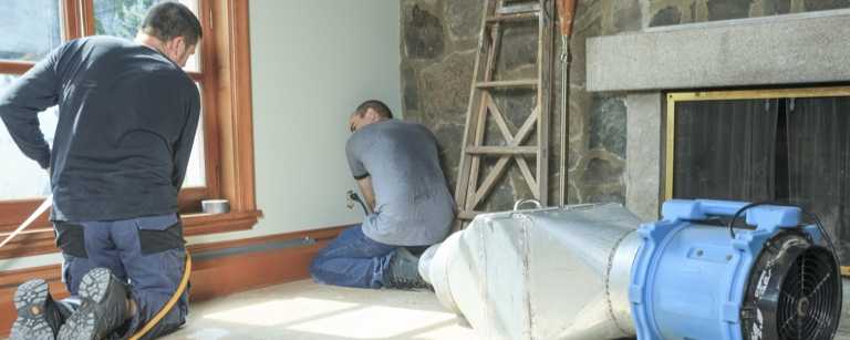 Contractors installing a house