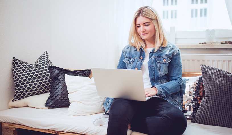 These tips can help you successfully work from home, just like this small business owner on her laptop.