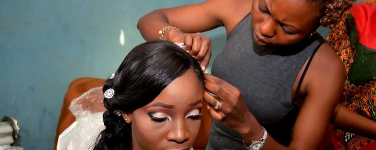 Hair salon employee styling a bride's hair