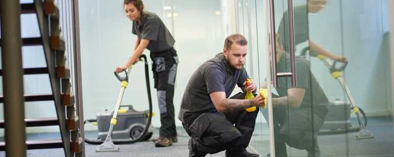 Janitorial staff cleaning an office