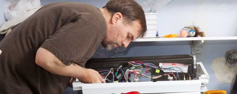 A man wiring an appliance
