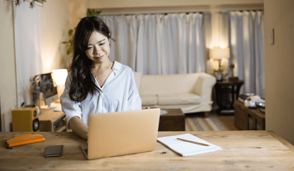 A woman on her laptop learning how to start an LLC.