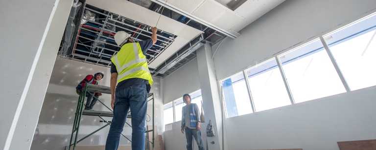 Commercial contractors inspect ceiling