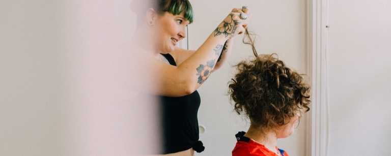 Hair salon employee styling a client's hair