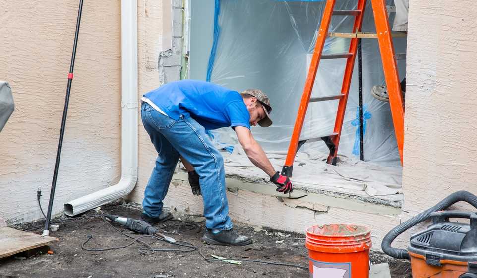 Our guidance can help you return to your job site safely, like this contractor working on a home entrance.