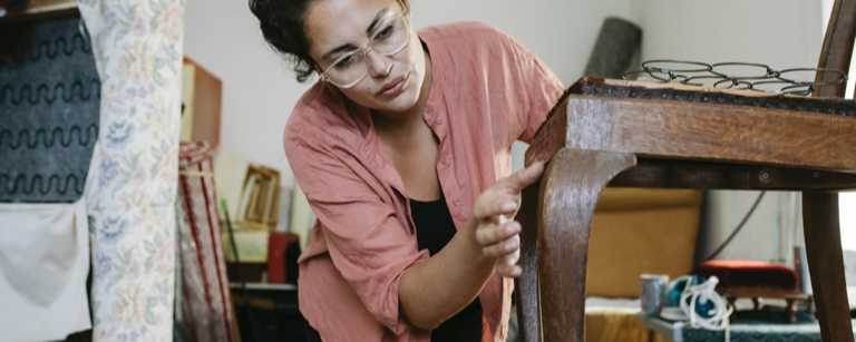 Upholsterer inspects the front of a chair