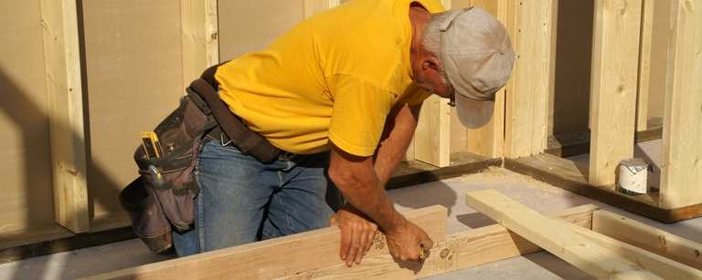 Builder measuring wood