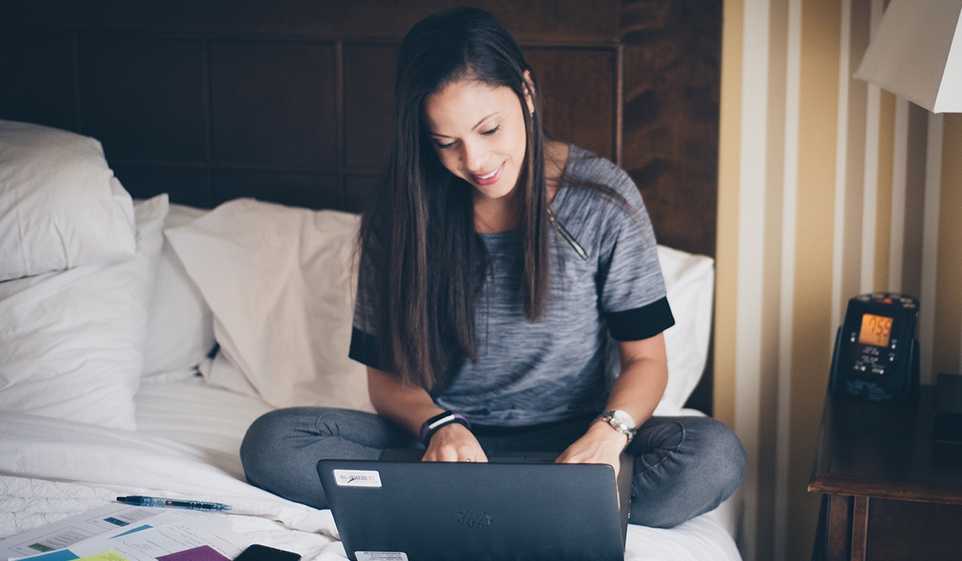 Our guide to SEO for your small business can be implemented right from your home, just like this business owner is doing on her laptop.
