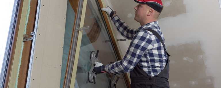 Glazier installing a window inside a commercial building