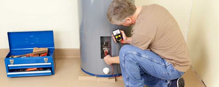Water treatment technician uses meter to check system
