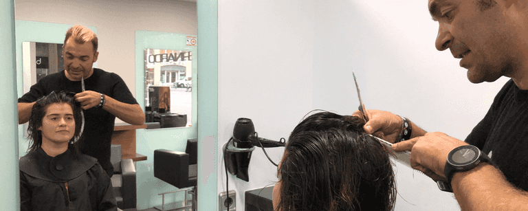Barber cuts client's hair