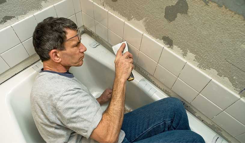 If you’ve got a knack for fixing things, like this man tiling a bathroom, you might have a career as a general contractor.