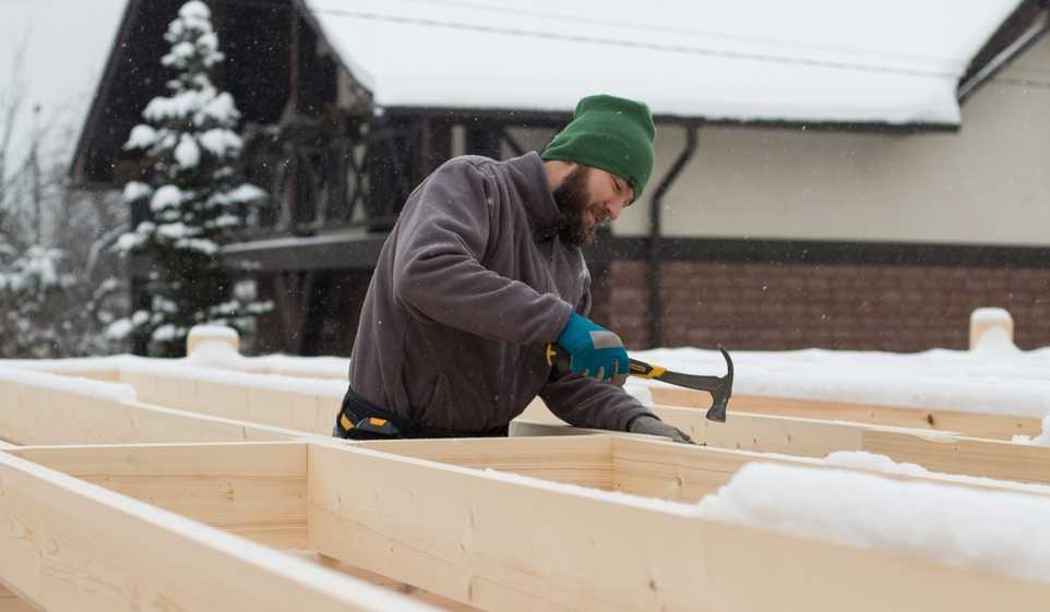 A contractor with a Minnesota business license works on framing.