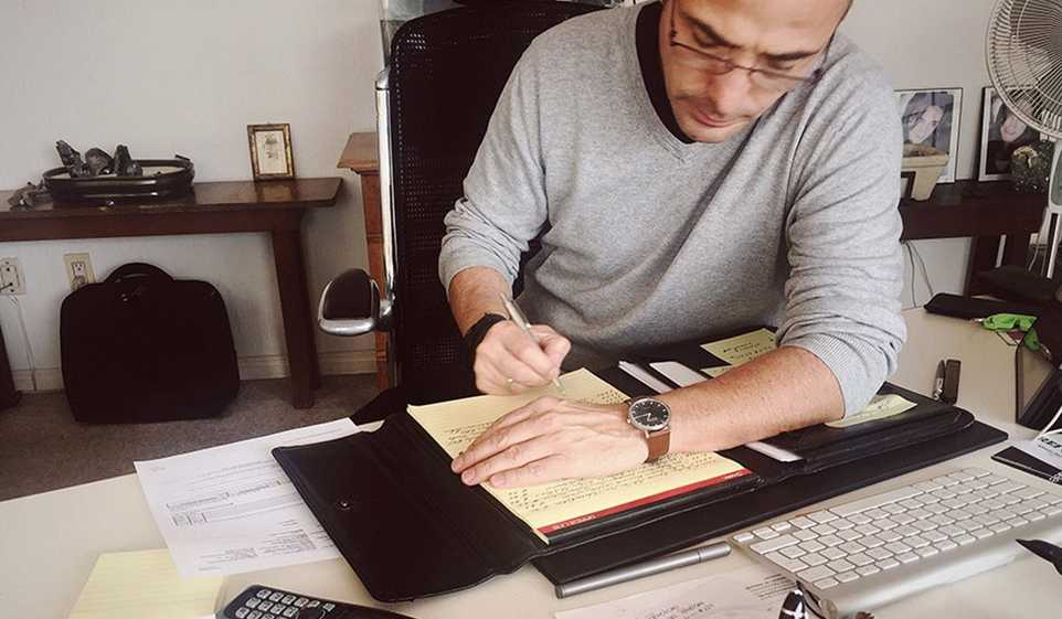 Tax season is coming up - make sure you're preparing for it, like this small business owner at his desk.